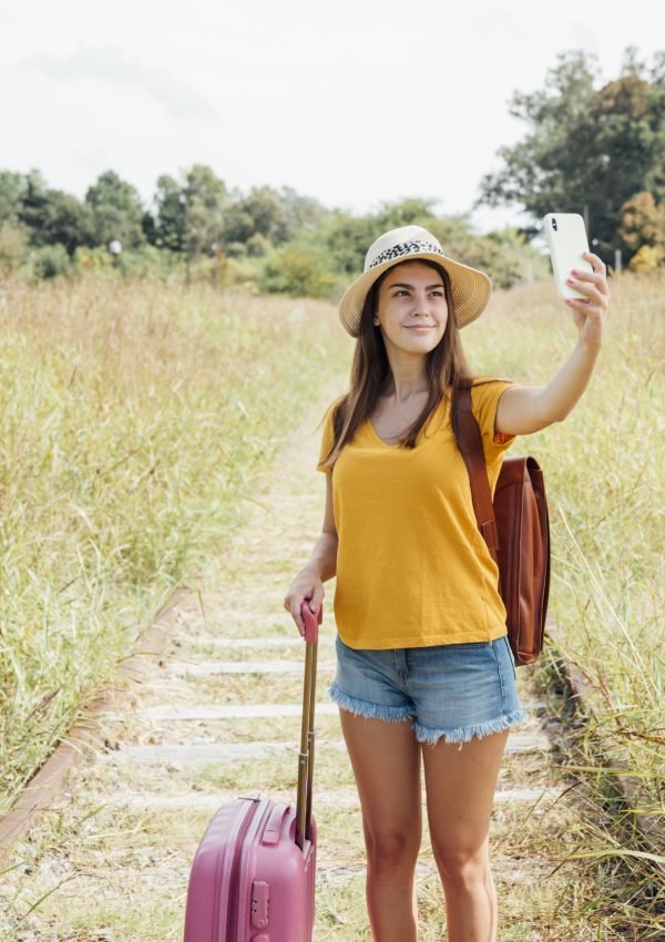 young-traveler-with-luggage-taking-selfie